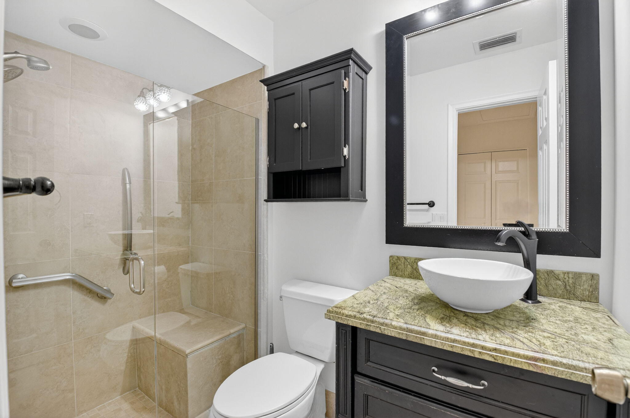 18051 104th Terrace South Boca Raton, FL 33498 - Photo 25 of 46 a bathroom with a granite countertop sink toilet a mirror and shower
