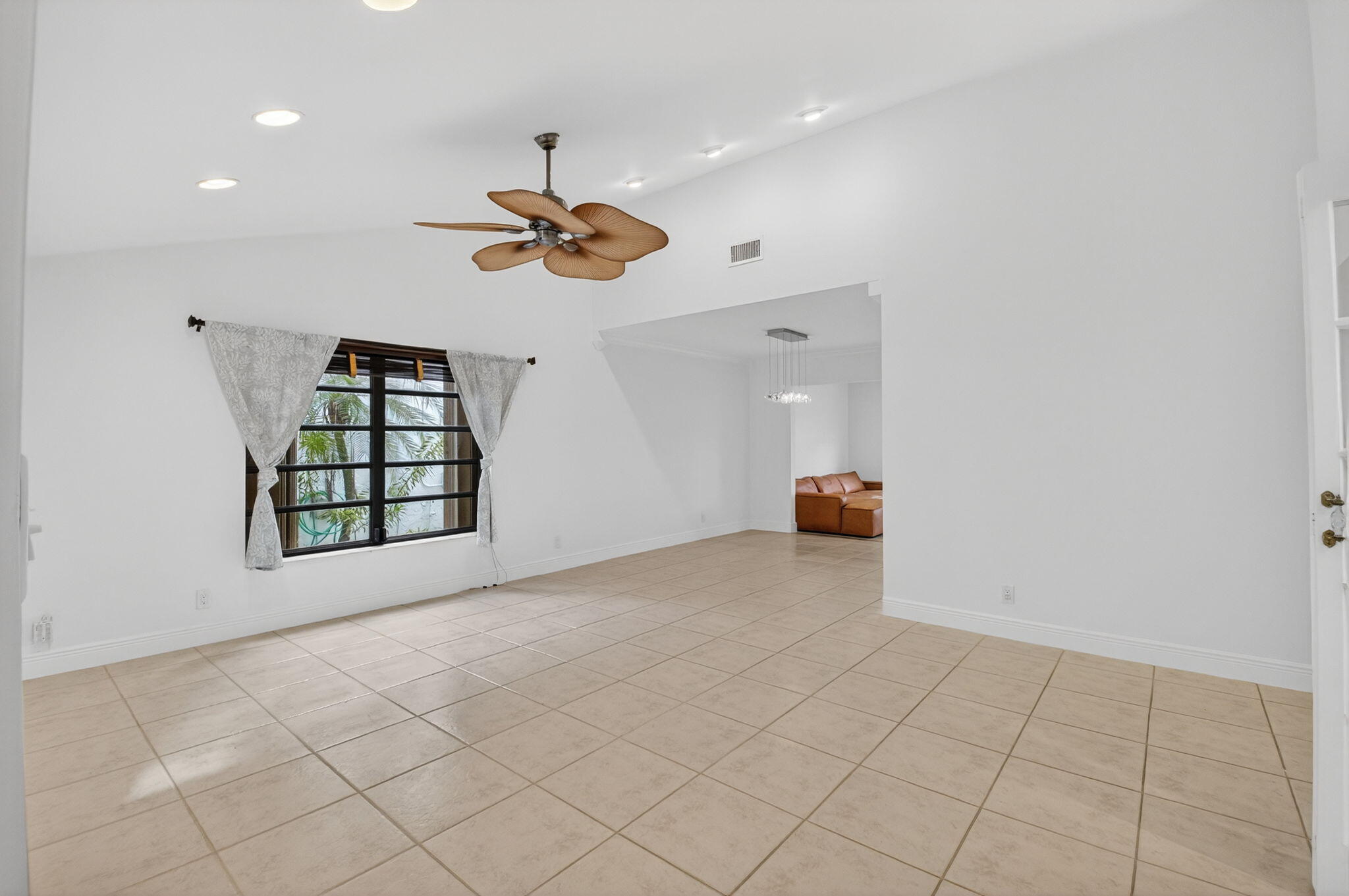 18051 104th Terrace South Boca Raton, FL 33498 - Photo 4 of 46 an empty room with windows and ceiling fan