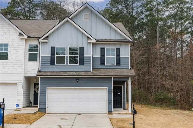 a front view of a house with garage