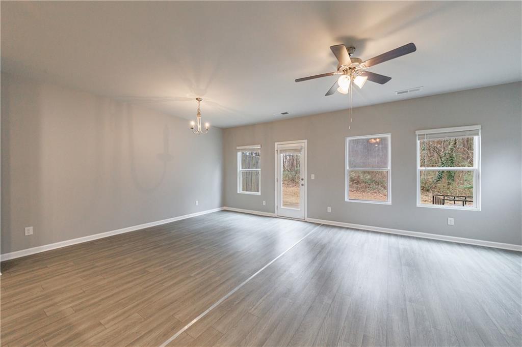 3413 Endurance Court Atlanta, GA 30349 - Photo 18 of 44 a view of an empty room with wooden floor and a window