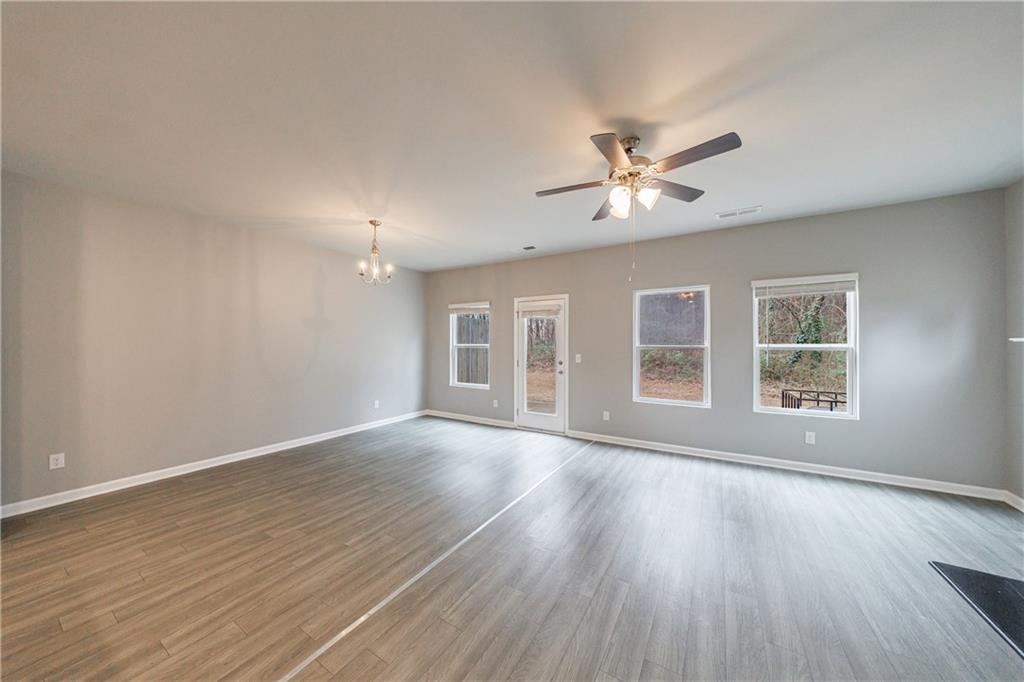 3413 Endurance Court Atlanta, GA 30349 - Photo 23 of 44 a view of an empty room with a window and wooden floor