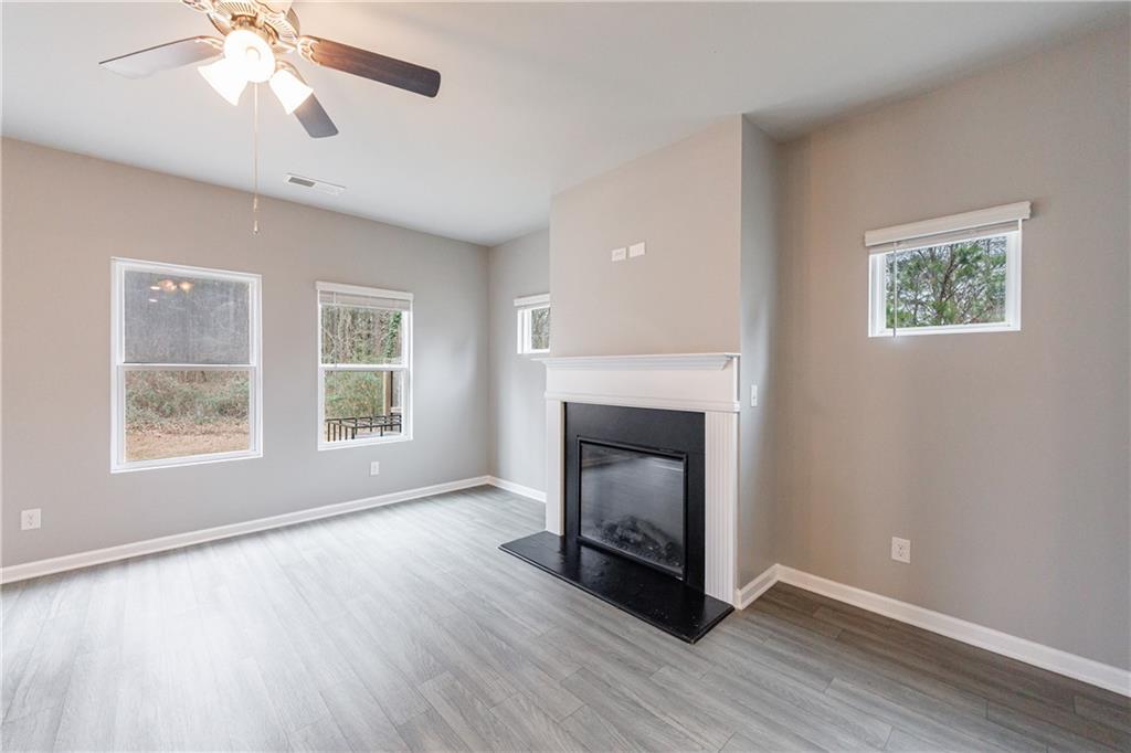 3413 Endurance Court Atlanta, GA 30349 - Photo 24 of 44 a view of an empty room with wooden floor and a window
