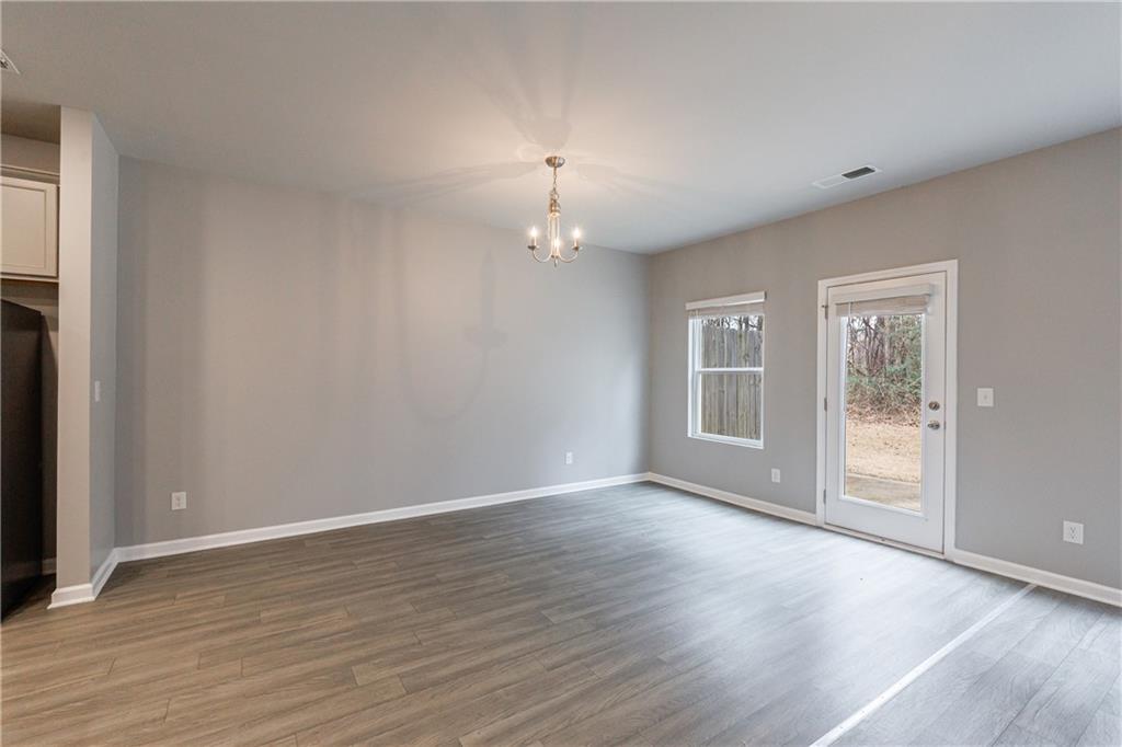 3413 Endurance Court Atlanta, GA 30349 - Photo 25 of 44 a view of an empty room with wooden floor and a window