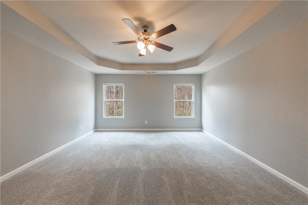 3413 Endurance Court Atlanta, GA 30349 - Photo 29 of 44 a view of an empty room with chandelier fan and a window