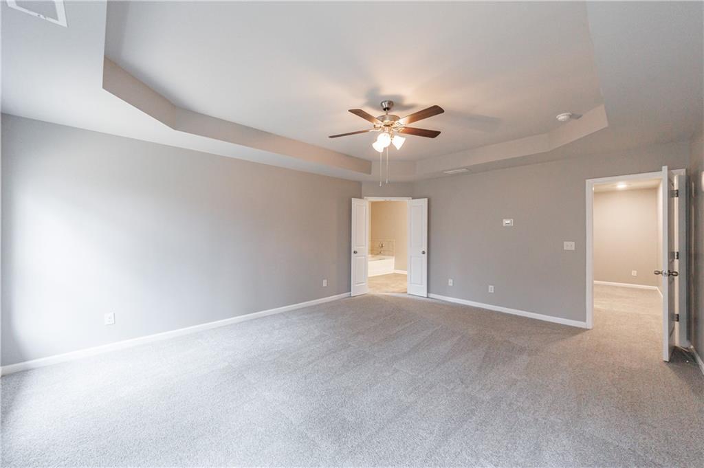 3413 Endurance Court Atlanta, GA 30349 - Photo 30 of 44 an empty room with a bathroom and a ceiling fan