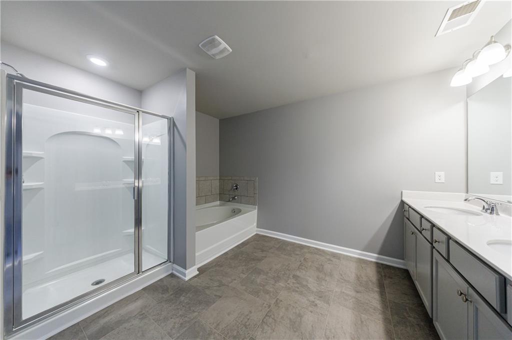 3413 Endurance Court Atlanta, GA 30349 - Photo 32 of 44 a bathroom with a sink and shower