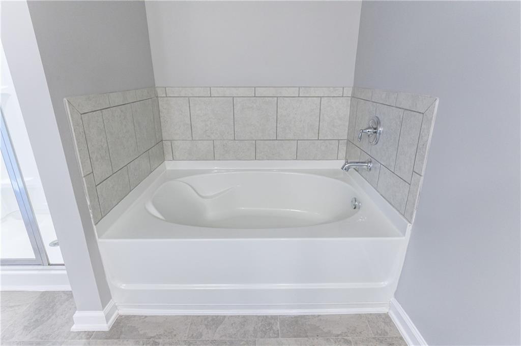 3413 Endurance Court Atlanta, GA 30349 - Photo 35 of 44 a white bath tub sitting next to a white sink