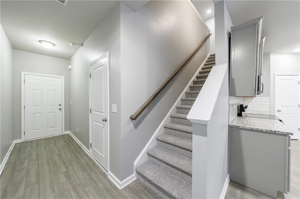 3413 Endurance Court Atlanta, GA 30349 - Photo 8 of 44 a view of a hallway with wooden floor and entryway