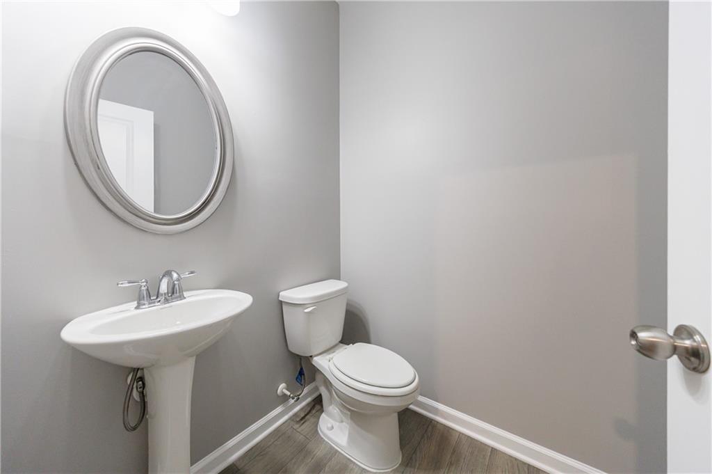 3413 Endurance Court Atlanta, GA 30349 - Photo 9 of 44 a bathroom with a toilet a sink and a mirror