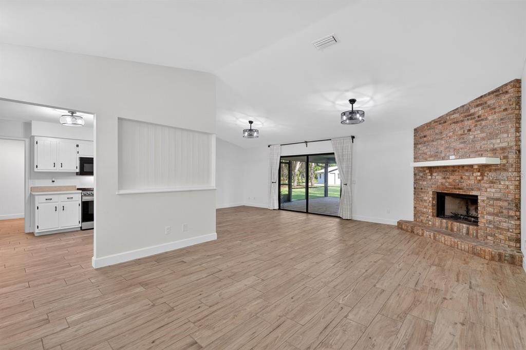 171 William Street Edgewater, FL 32141 - Photo 7 of 40 a view of a kitchen with an empty space and a fireplace