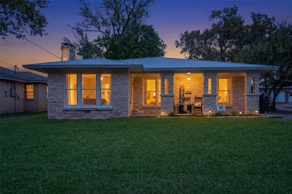 a front view of house with yard and outdoor seating