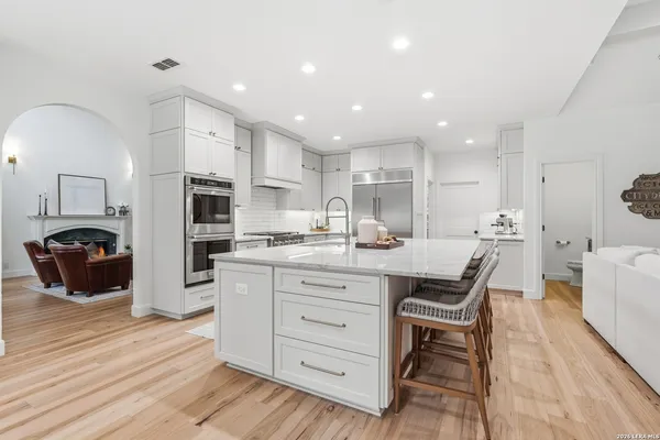 a kitchen with stainless steel appliances kitchen island granite countertop a sink and cabinets