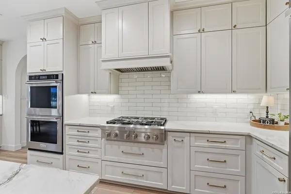 a kitchen with granite countertop cabinets and steel stainless steel appliances