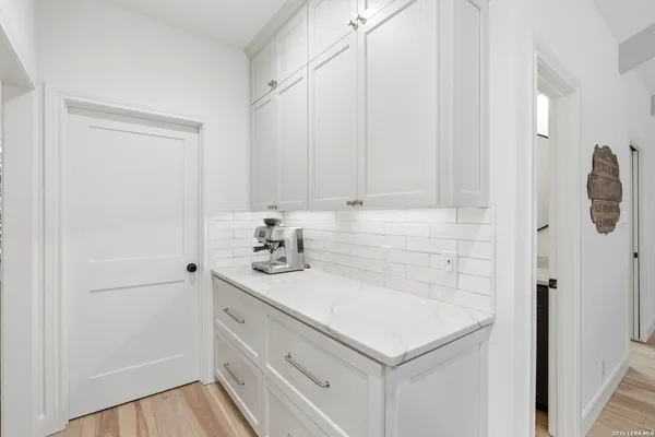 a utility room with cabinets washer and dryer
