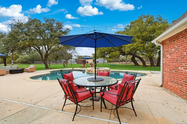 a view of yard with seating area and barbeque oven
