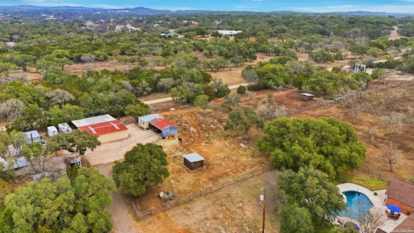 an aerial view of residential houses with outdoor space and river