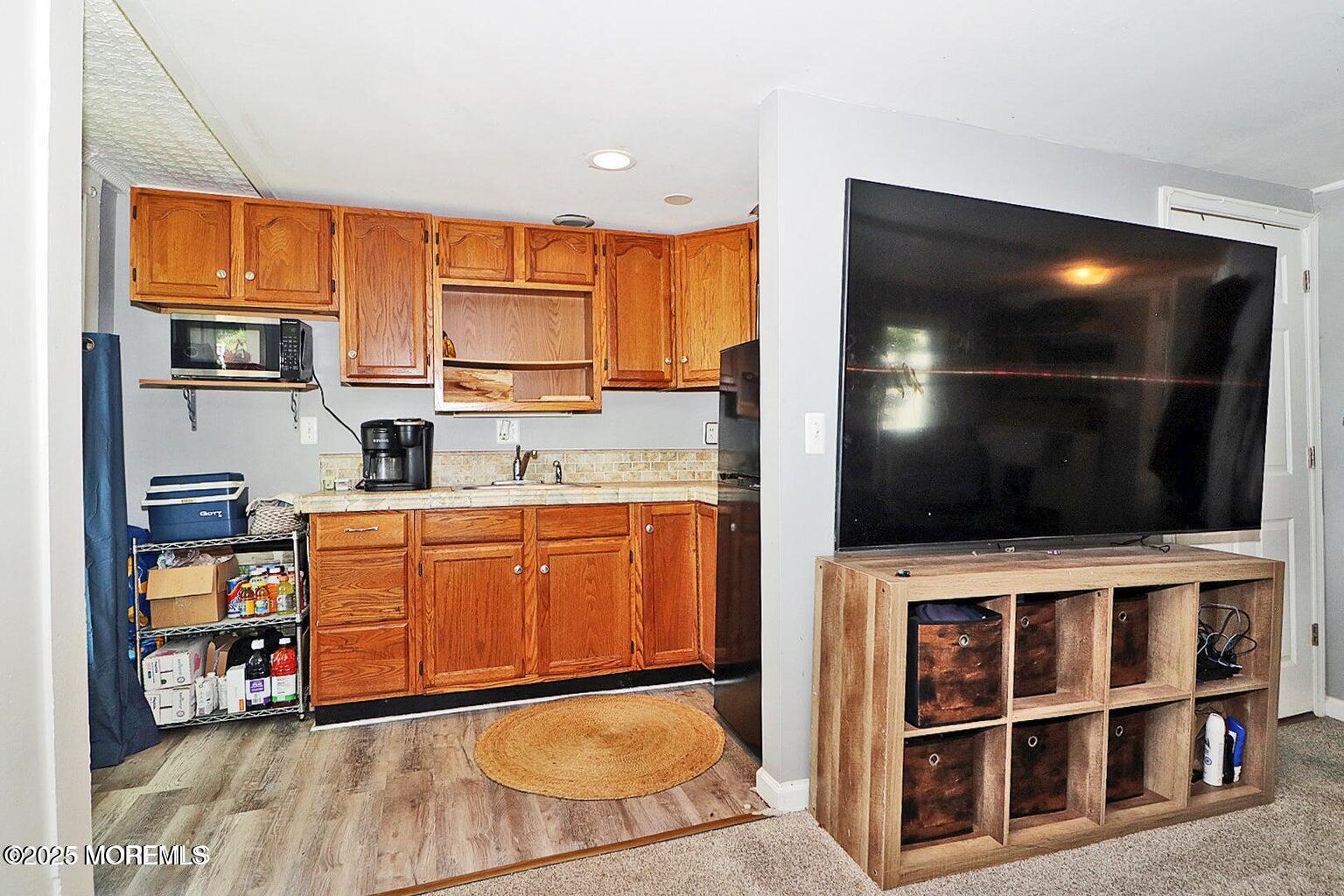 a view of kitchen with microwave and cabinets