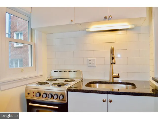 a kitchen with a stove and a sink