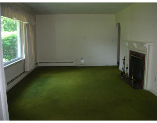 281 North Road Sudbury, MA 01776 - Photo 6 of 12 an empty room with a fireplace and a window