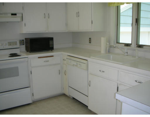 281 North Road Sudbury, MA 01776 - Photo 8 of 12 a kitchen with white cabinets and white appliances