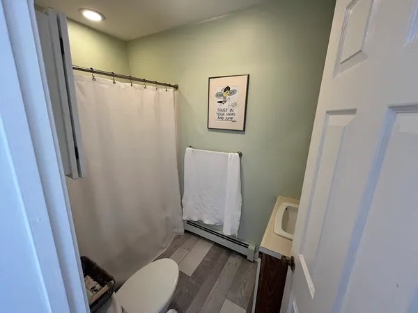a bathroom with sink toilet and a mirror