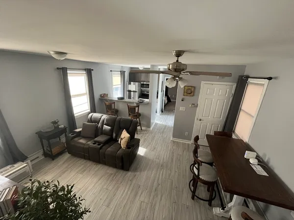 a living room with furniture and wooden floor