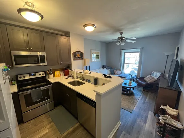 a kitchen with sink stove and refrigerator