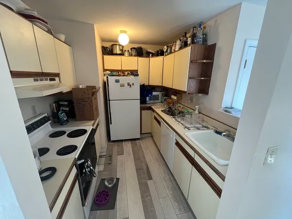 a kitchen with a refrigerator and a sink