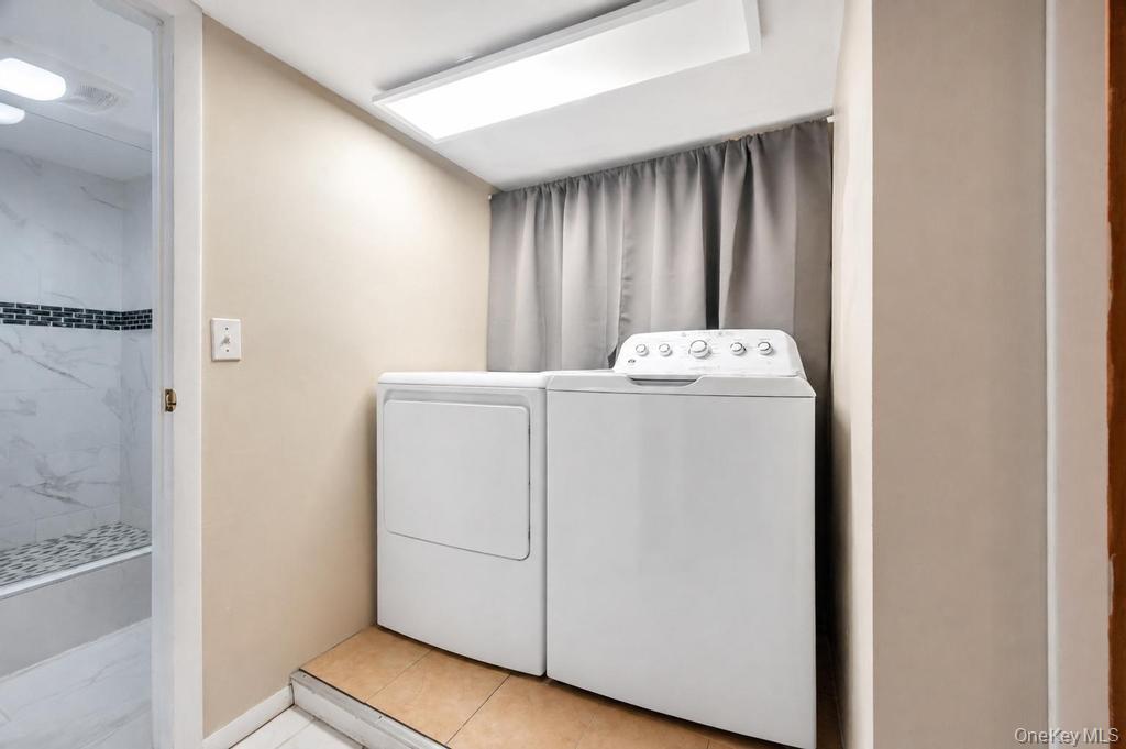 89-13 84th Street Queens, NY 11421 - Photo 34 of 34 Dedicated laundry area featuring a white washer and dryer pair