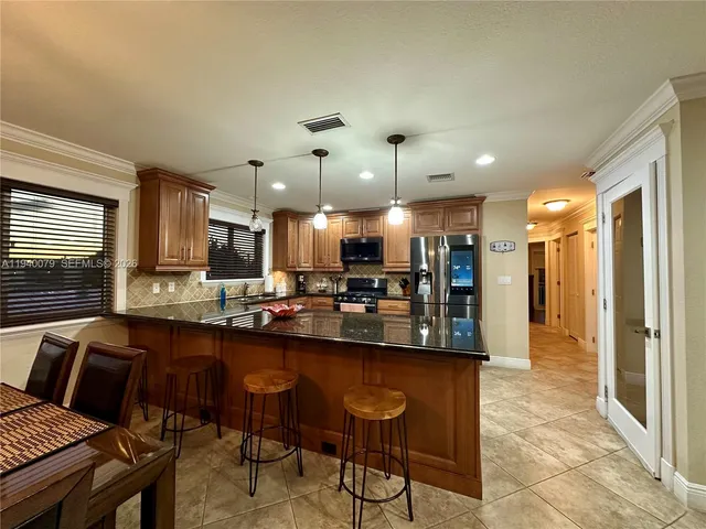 a kitchen with a stove top oven sink and cabinets