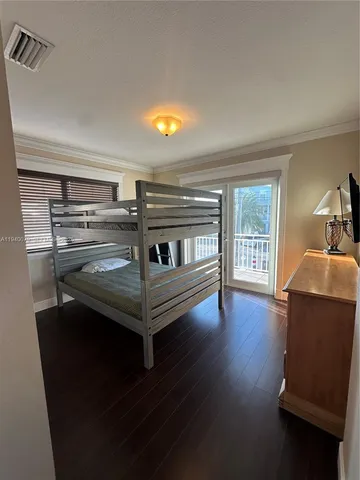 a spacious bedroom with a large bed and a dresser