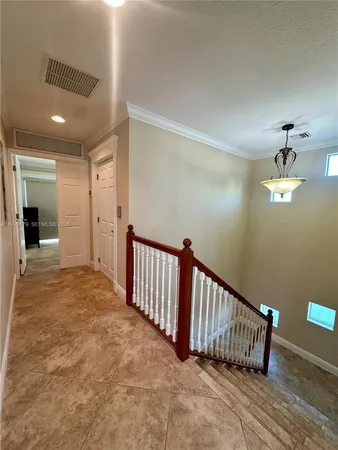 a spacious bedroom with a bed and glass door