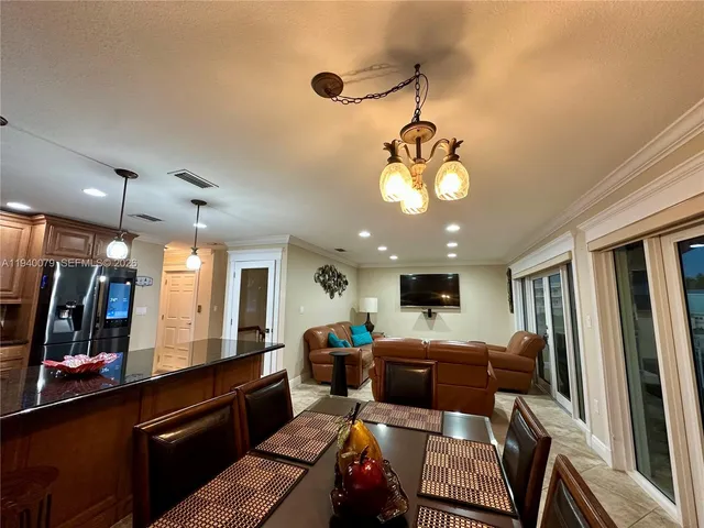 a living room with lots of furniture and kitchen view