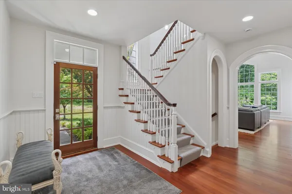 a view of entryway and hall with wooden floor