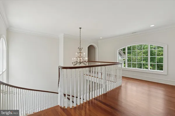 a view of staircase with wooden floor and window