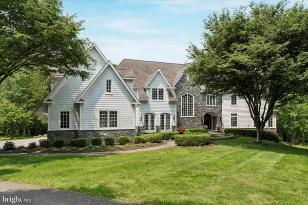 a front view of house with yard and green space
