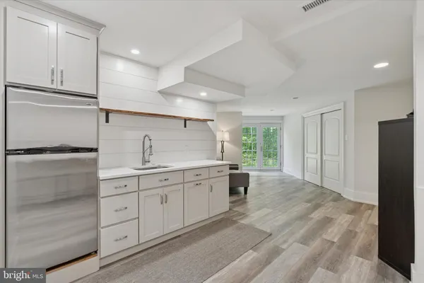 a large kitchen with a refrigerator and a sink