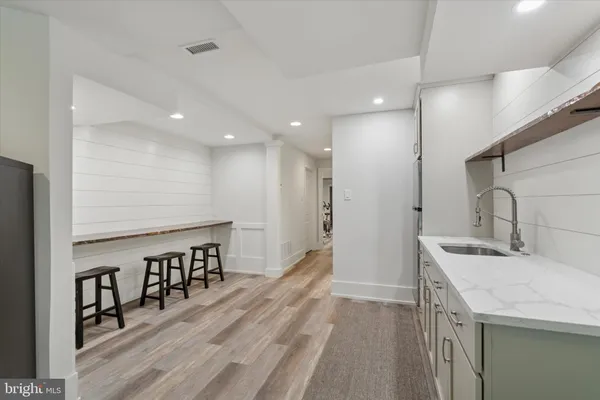 a kitchen with stainless steel appliances granite countertop a sink a stove and a refrigerator