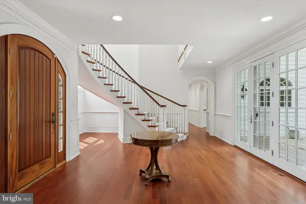 a view of entryway and hall with wooden floor