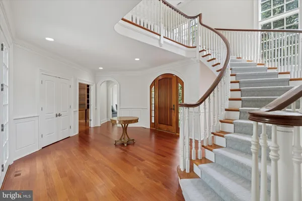 a view of entryway and hall with wooden floor