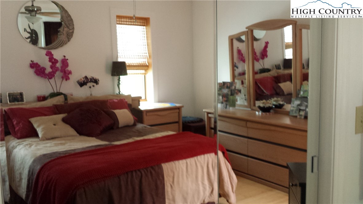 1339 Hopewell Church Road Boone, NC 28607 - Photo 23 of 35 a bedroom with a bed and a mirror