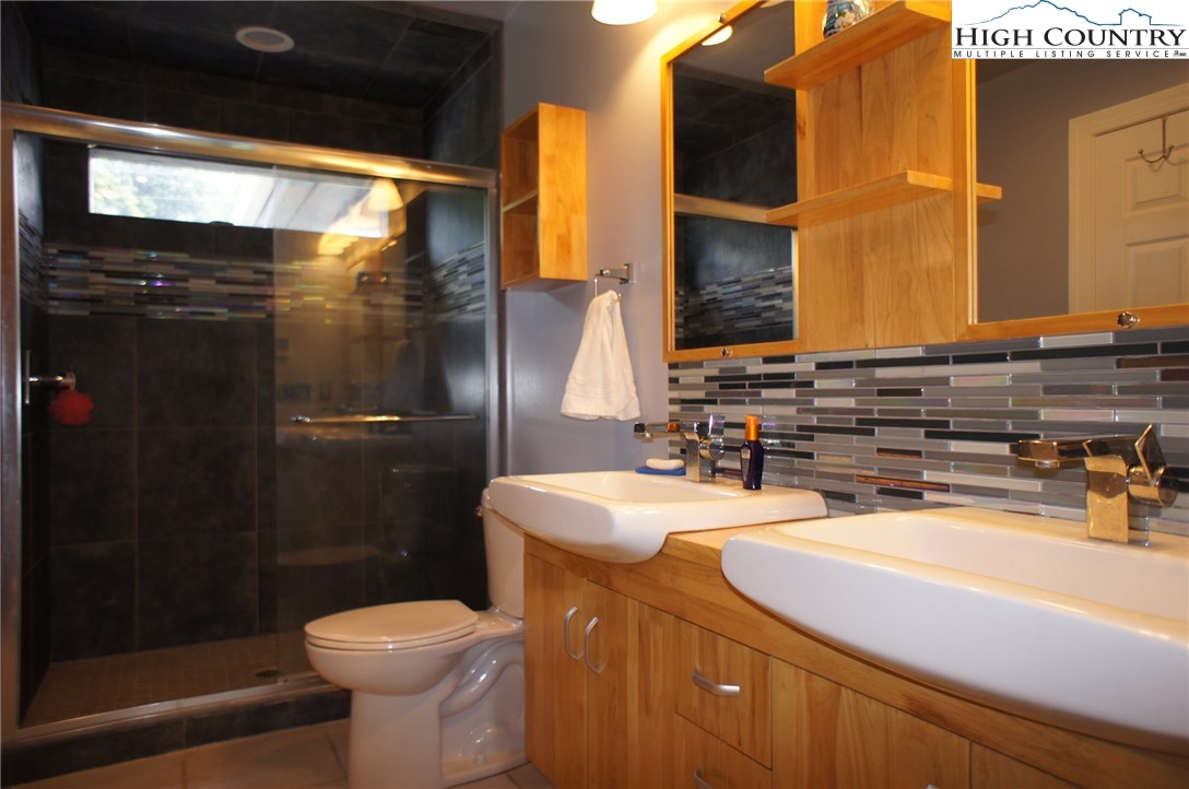 1339 Hopewell Church Road Boone, NC 28607 - Photo 24 of 35 a bathroom with a sink a toilet and shower