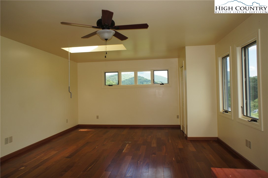 1339 Hopewell Church Road Boone, NC 28607 - Photo 29 of 35 an empty room with wooden floor and windows