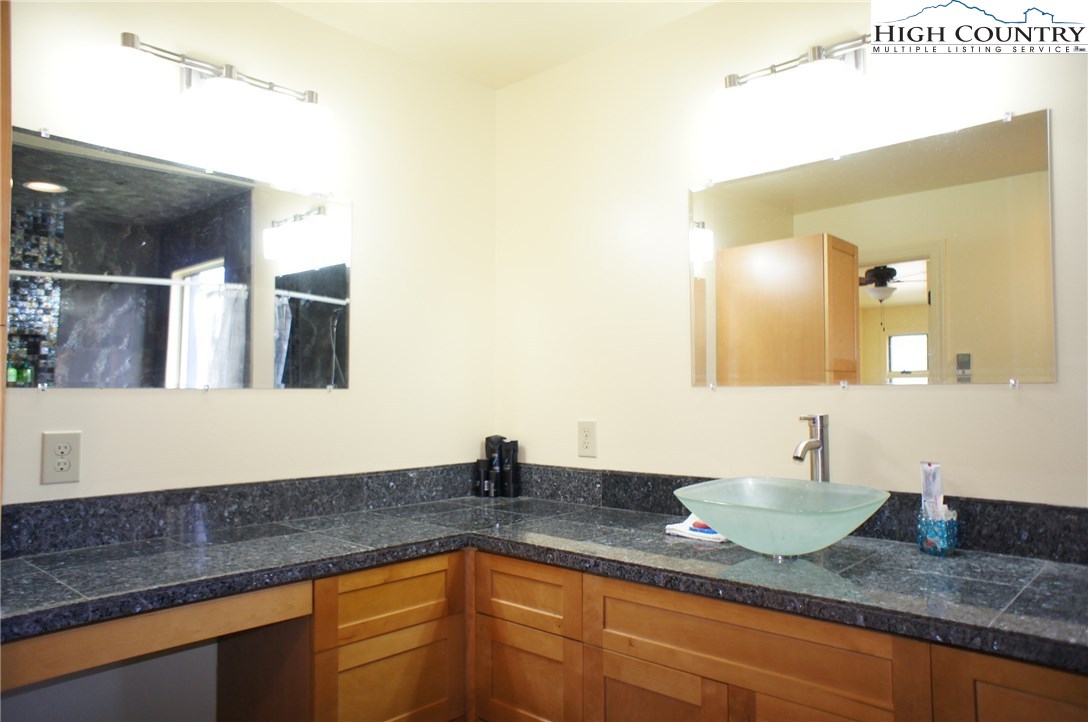 1339 Hopewell Church Road Boone, NC 28607 - Photo 31 of 35 a bathroom with a granite countertop sink and a mirror