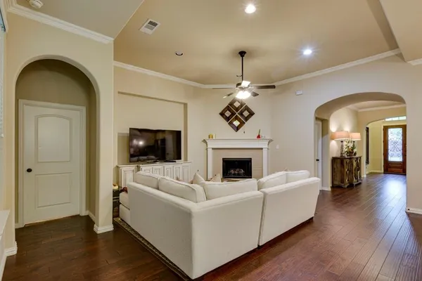 a living room with furniture a flat screen tv and a fireplace
