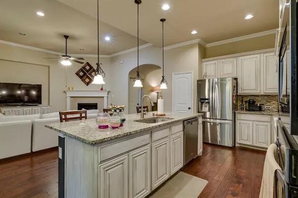 a kitchen with stainless steel appliances granite countertop a sink refrigerator and microwave