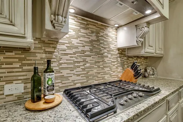 a kitchen with a stove and cabinets