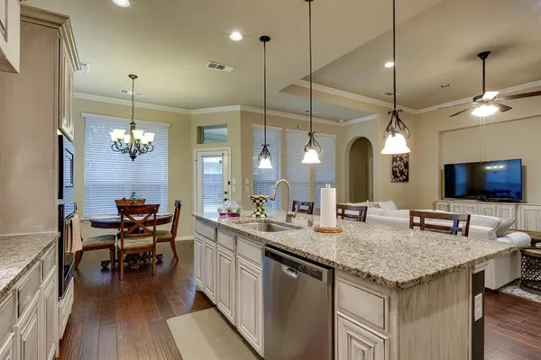 a kitchen with center island table and chairs in it
