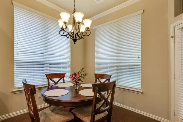 a view of a dining room with furniture and chandelier