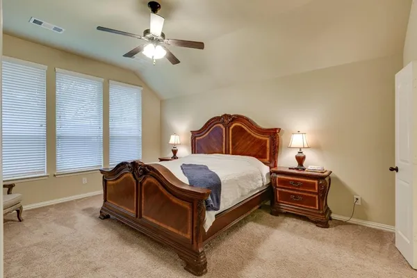 a bedroom with a bed and a ceiling fan
